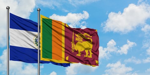 El Salvador and Sri Lanka flag waving in the wind against white cloudy blue sky together. Diplomacy concept, international relations.