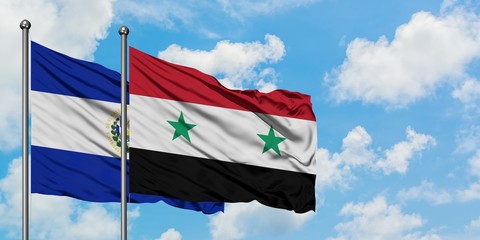 El Salvador and Syria flag waving in the wind against white cloudy blue sky together. Diplomacy...