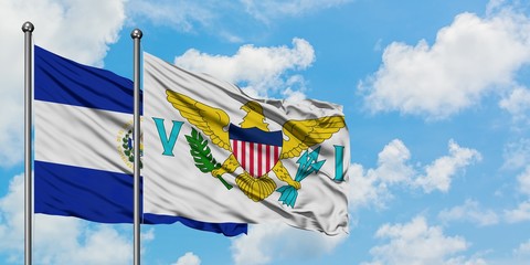 El Salvador and United States Virgin Islands flag waving in the wind against white cloudy blue sky together. Diplomacy concept, international relations.