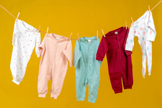 Clothesline with pinned baby clothes close up