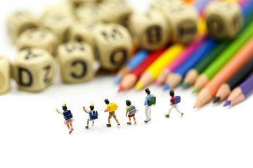 Miniature people : children and student with stationary,education concept.