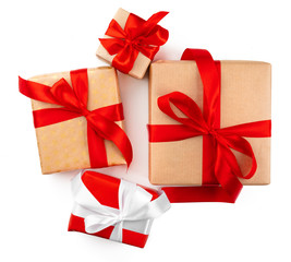 Craft christmas gifts with red bows isolated on white background, top view