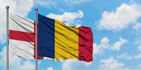 England and Chad flag waving in the wind against white cloudy blue sky together. Diplomacy concept, international relations.