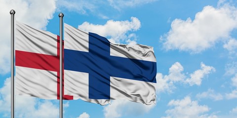 England and Finland flag waving in the wind against white cloudy blue sky together. Diplomacy concept, international relations.