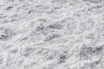 White sea foam off the coast. Background