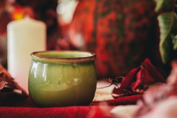 Autumn decor with pumpkin, candles and tableware