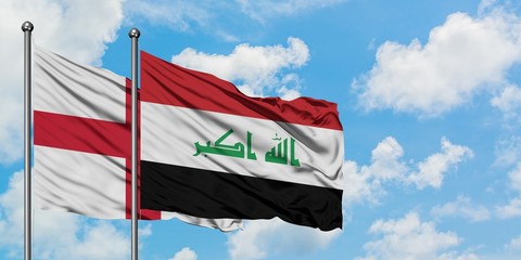 England and Iraq flag waving in the wind against white cloudy blue sky together. Diplomacy concept, international relations.