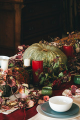 Fall thanksgiving decor with candle and pumpkins close up