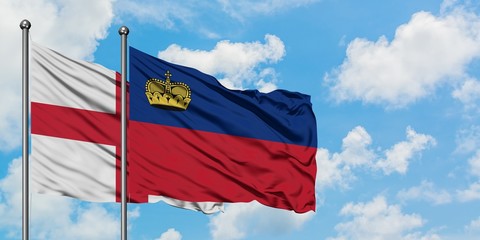 England and Liechtenstein flag waving in the wind against white cloudy blue sky together. Diplomacy concept, international relations.