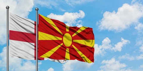 England and Macedonia flag waving in the wind against white cloudy blue sky together. Diplomacy concept, international relations.