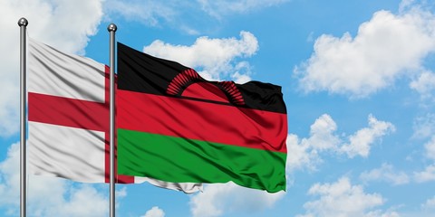 England and Malawi flag waving in the wind against white cloudy blue sky together. Diplomacy concept, international relations.