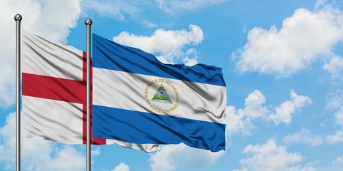 England and Nicaragua flag waving in the wind against white cloudy blue sky together. Diplomacy concept, international relations.
