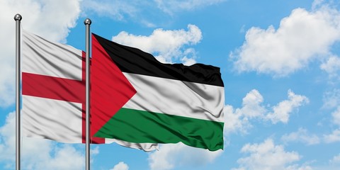 England and Palestine flag waving in the wind against white cloudy blue sky together. Diplomacy concept, international relations.