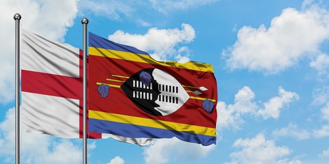 England and Swaziland flag waving in the wind against white cloudy blue sky together. Diplomacy concept, international relations.