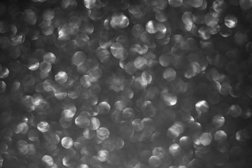 Blurred abstract monochrome glitter texture, defocused christmas lights. Holiday and christmas concept.
