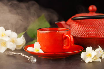 Glass cup of tea with jasmine flowers