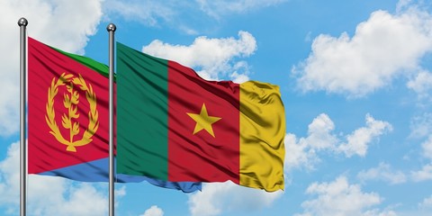 Eritrea and Cameroon flag waving in the wind against white cloudy blue sky together. Diplomacy concept, international relations.