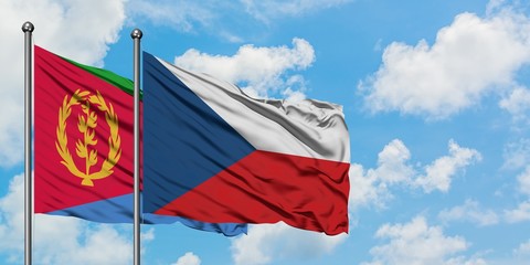 Eritrea and Czech Republic flag waving in the wind against white cloudy blue sky together. Diplomacy concept, international relations.