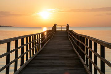 Fototapeta na wymiar romantic seascape, with sea bridge at sunset, desktop image