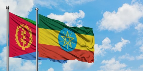Eritrea and Ethiopia flag waving in the wind against white cloudy blue sky together. Diplomacy concept, international relations.