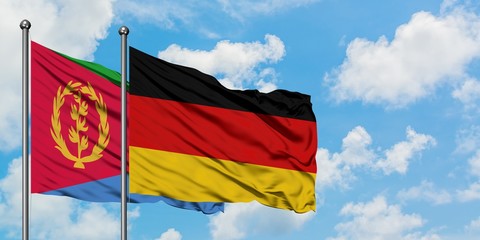 Eritrea and Germany flag waving in the wind against white cloudy blue sky together. Diplomacy concept, international relations.