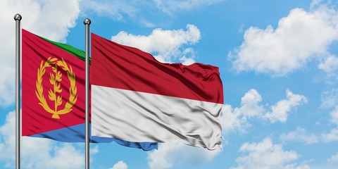 Eritrea and Indonesia flag waving in the wind against white cloudy blue sky together. Diplomacy concept, international relations.