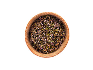 Dry Calluna vulgaris in wooden Cup on white background