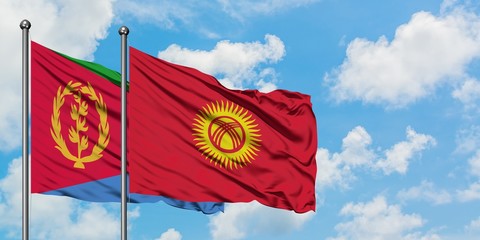 Eritrea and Kyrgyzstan flag waving in the wind against white cloudy blue sky together. Diplomacy concept, international relations.