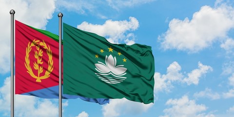 Eritrea and Macao flag waving in the wind against white cloudy blue sky together. Diplomacy concept, international relations.