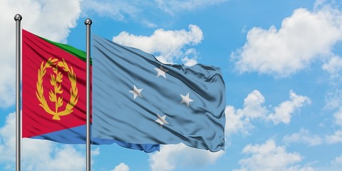 Eritrea and Micronesia flag waving in the wind against white cloudy blue sky together. Diplomacy concept, international relations.