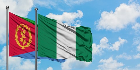 Eritrea and Nigeria flag waving in the wind against white cloudy blue sky together. Diplomacy concept, international relations.