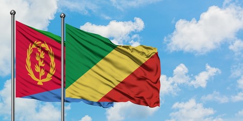 Eritrea and Republic Of The Congo flag waving in the wind against white cloudy blue sky together. Diplomacy concept, international relations.