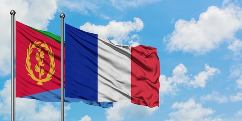 Eritrea and Reunion flag waving in the wind against white cloudy blue sky together. Diplomacy concept, international relations.