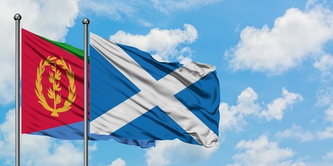 Eritrea and Scotland flag waving in the wind against white cloudy blue sky together. Diplomacy concept, international relations.
