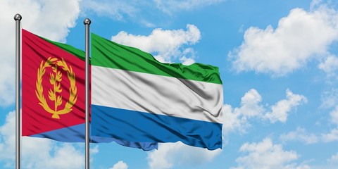 Eritrea and Sierra Leone flag waving in the wind against white cloudy blue sky together. Diplomacy concept, international relations.