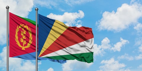 Eritrea and Seychelles flag waving in the wind against white cloudy blue sky together. Diplomacy concept, international relations.