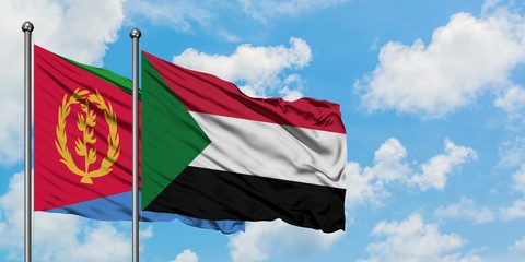Eritrea and Sudan flag waving in the wind against white cloudy blue sky together. Diplomacy concept, international relations.