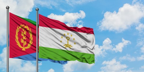 Eritrea and Tajikistan flag waving in the wind against white cloudy blue sky together. Diplomacy concept, international relations.