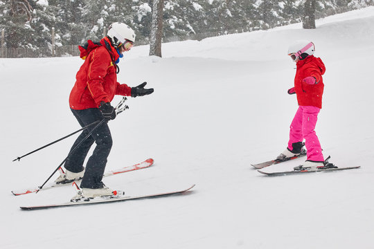 Child Learning How To Ski With An Instructor. Winter