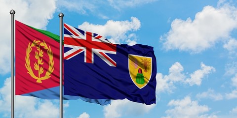Eritrea and Turks And Caicos Islands flag waving in the wind against white cloudy blue sky together. Diplomacy concept, international relations.