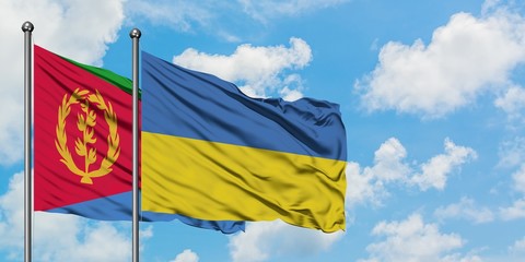 Eritrea and Ukraine flag waving in the wind against white cloudy blue sky together. Diplomacy concept, international relations.