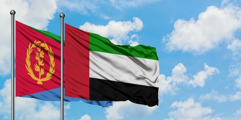 Eritrea and United Arab Emirates flag waving in the wind against white cloudy blue sky together. Diplomacy concept, international relations.