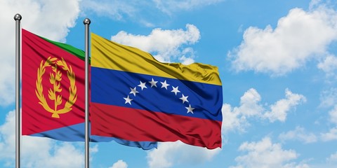 Eritrea and Venezuela flag waving in the wind against white cloudy blue sky together. Diplomacy concept, international relations.
