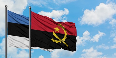 Estonia and Angola flag waving in the wind against white cloudy blue sky together. Diplomacy concept, international relations.