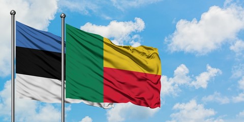 Estonia and Benin flag waving in the wind against white cloudy blue sky together. Diplomacy concept, international relations.