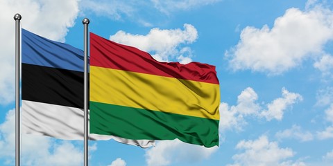 Estonia and Bolivia flag waving in the wind against white cloudy blue sky together. Diplomacy concept, international relations.