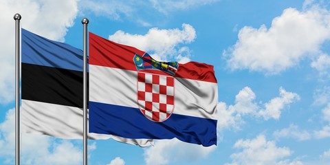 Estonia and Croatia flag waving in the wind against white cloudy blue sky together. Diplomacy concept, international relations.