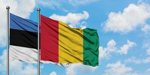 Estonia and Guinea flag waving in the wind against white cloudy blue sky together. Diplomacy concept, international relations.