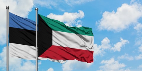 Estonia and Kuwait flag waving in the wind against white cloudy blue sky together. Diplomacy concept, international relations.