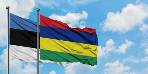 Estonia and Mauritius flag waving in the wind against white cloudy blue sky together. Diplomacy concept, international relations.